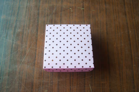 Pink gift box on dark wooden backgroundの写真素材