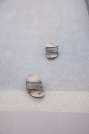 pair old slippers on cement ground
