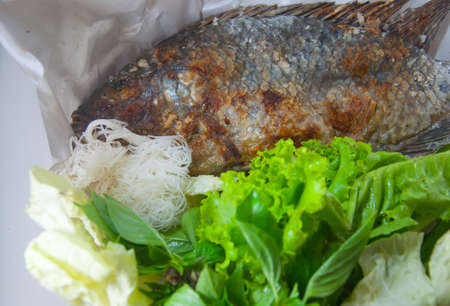 fish grilled with salt is thai food.it has many vegetable, noodles and spicy sauce(sea food sauce)の写真素材