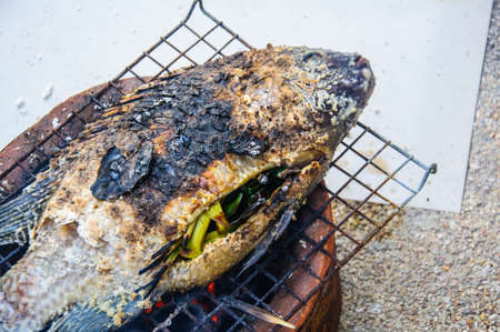 Fish cover on skin by salt grill on the stove
