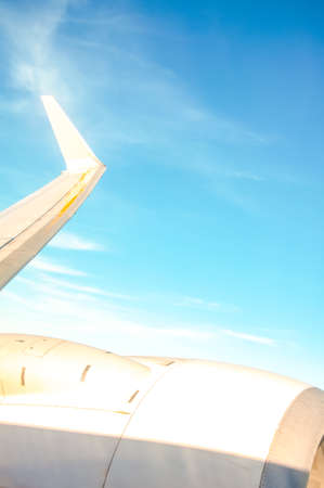 airplane window with wing and cloudscapeの写真素材