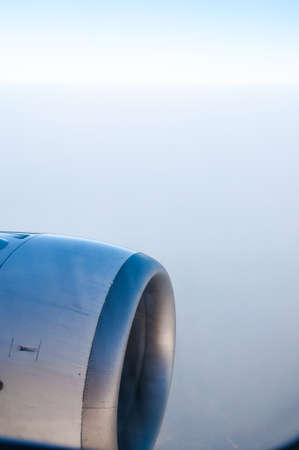 Clouds and sky as seen through window of an aircraftの写真素材