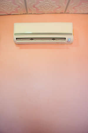 Air conditioner on pink wallの写真素材