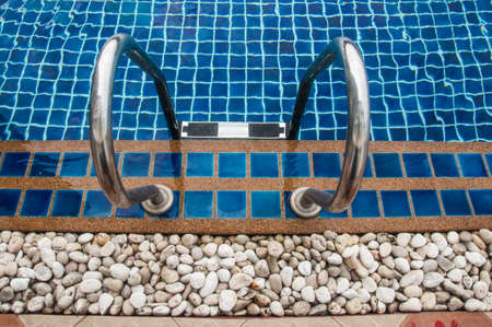 Swimming pool with stair and blue relaxing waterの写真素材