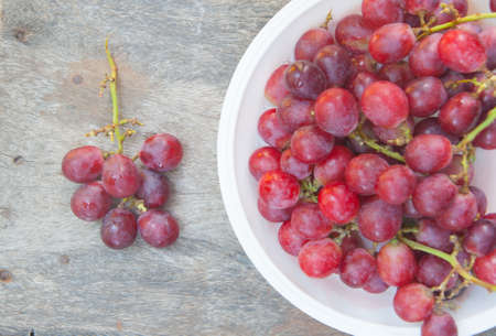fresh grapes on a wooden tableの写真素材