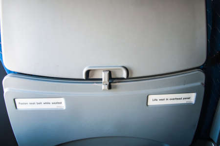 fasten seat belt while seated sign on airplaneの写真素材