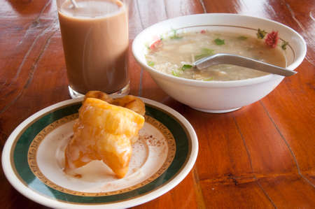 Rice Porridge served with deep-fried dough stick and hot cocoaの写真素材