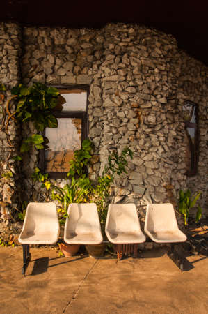 old chair with bricks and window wallの写真素材