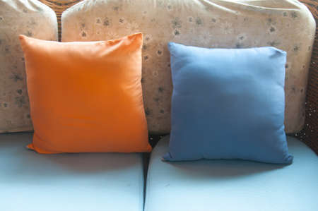 orange and blue apillows on sofa, close-upの写真素材