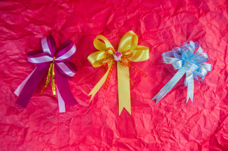 set of colorful gift bows on redの写真素材