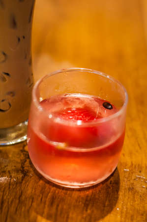 glass of red watermelon on wood table