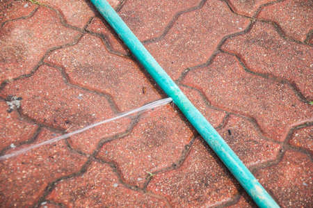 Water leaking on pvc discharge hose in construction siteの写真素材