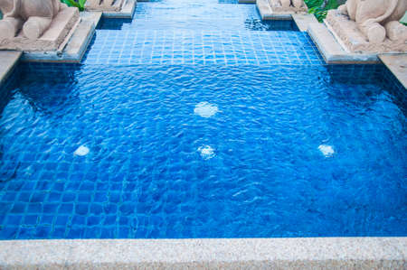 Close up of an outdoor pool with waterfall, swimming poolの写真素材