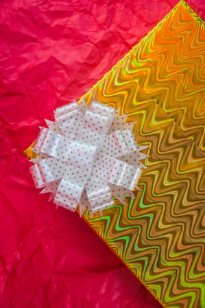 Golden gift box on red paperの写真素材