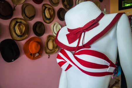 red woman swimming suit  in hats shopの写真素材