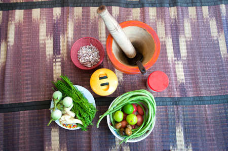Thailand Food Ingredients: Tomatoes, peppers, garlic, shallots, lemon with a mortarの写真素材