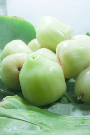 fresh green rose apple on banana leaf
