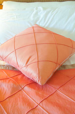 silk pink pillow on bed