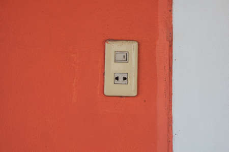 Electrical old switch and plug on pink wallの写真素材