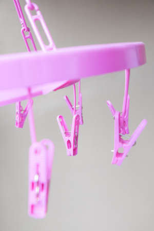 Pink plastic clothespins with hangerの写真素材