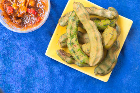 Fresh tamarind and dip sweet sauce blue backgroundの写真素材