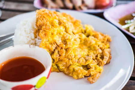 omelet served with steamed rice and chilli sauce on plate that is Thai Style Fast foodの写真素材