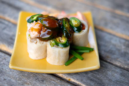 Sliced spring rolls on wood tableの写真素材