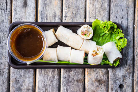 Fresh spring rolls, vegetables wrapped in dough, topped with crab , eaten with sweet sauceの写真素材
