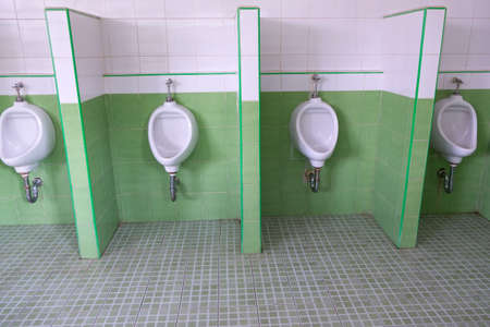 urinals in an old building for men onlyの写真素材