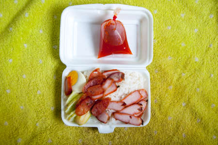 Crispy roasted belly pork chinese style and rice in foam box