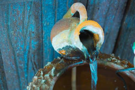 pottery in a water ditch with little fountainsの写真素材