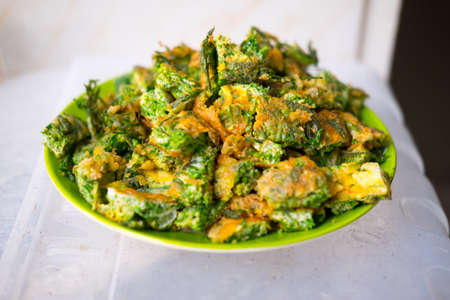 Thai Cuisine; cha-om omelet in green plateの写真素材