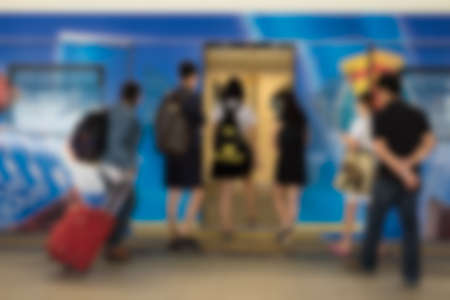 Abstract blurry image of BTS Station in Bangkok Thailand. People waiting, standing and walking on BTS sky trainの写真素材