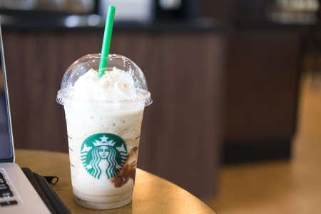Samutprakarn, Thailand - May 6, 2016: Glass of Starbuck coffee ice cappuccino blended beverages served on wooden table at starbucks coffee shop inside Home Pro Village , Suvarnabhumi
shopping mallのeditorial素材