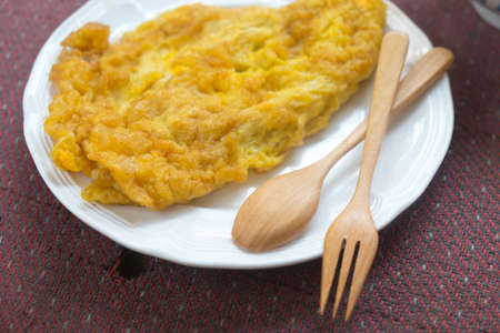 Thai style omelet in white plate