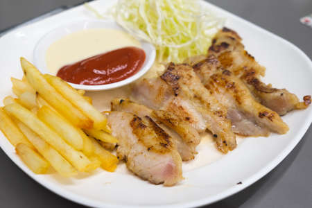 pork steak with french fries and salad.の写真素材