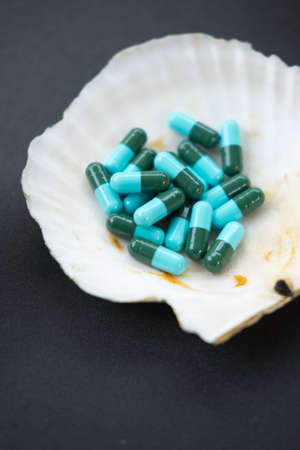 blue and green capsules with medicine antibiotic