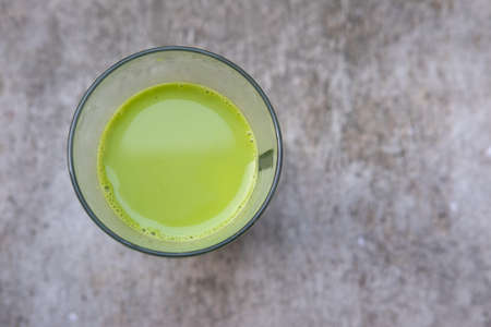 Milk green tea on stone background