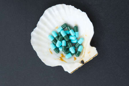 Close up of blue and green capsules, medicine antibiotic
