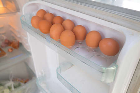 Eggs on a white shelf of the refrigeratorの写真素材