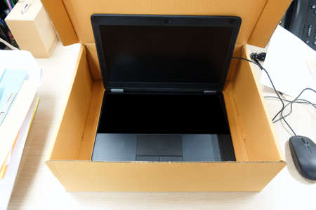 black laptop closeup in paper box