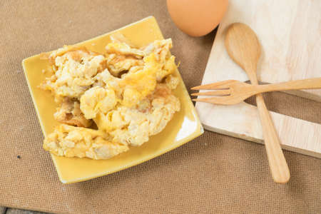 Thai omelet on yellow dish (Thai Style omelet)の写真素材