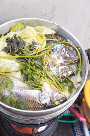 Steamed Nile tilapia fish and vegetables,Thai style foodの写真素材