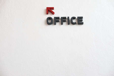 Arrows go to office on cement wallの写真素材