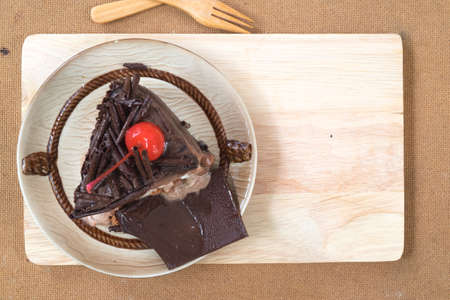 Chocolate cake slice with cherries toppingの写真素材