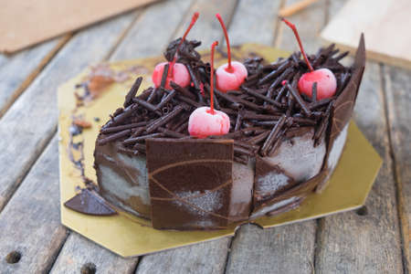 homemade cake decorated with sweets and cherries toppingの写真素材