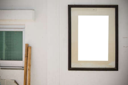 empty photo frame on old wall in home