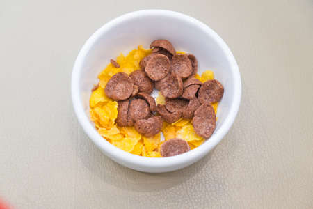 Cornflakes with milk in a white bowl