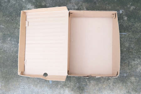 Opened of cardboard box on stone background