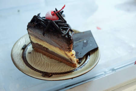 chocolate cake with cherries topping in refrigerator